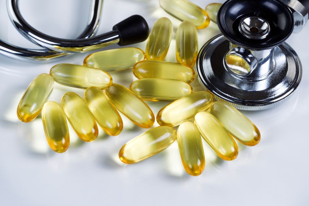 Close up of fish oil capsules for good health on plain background