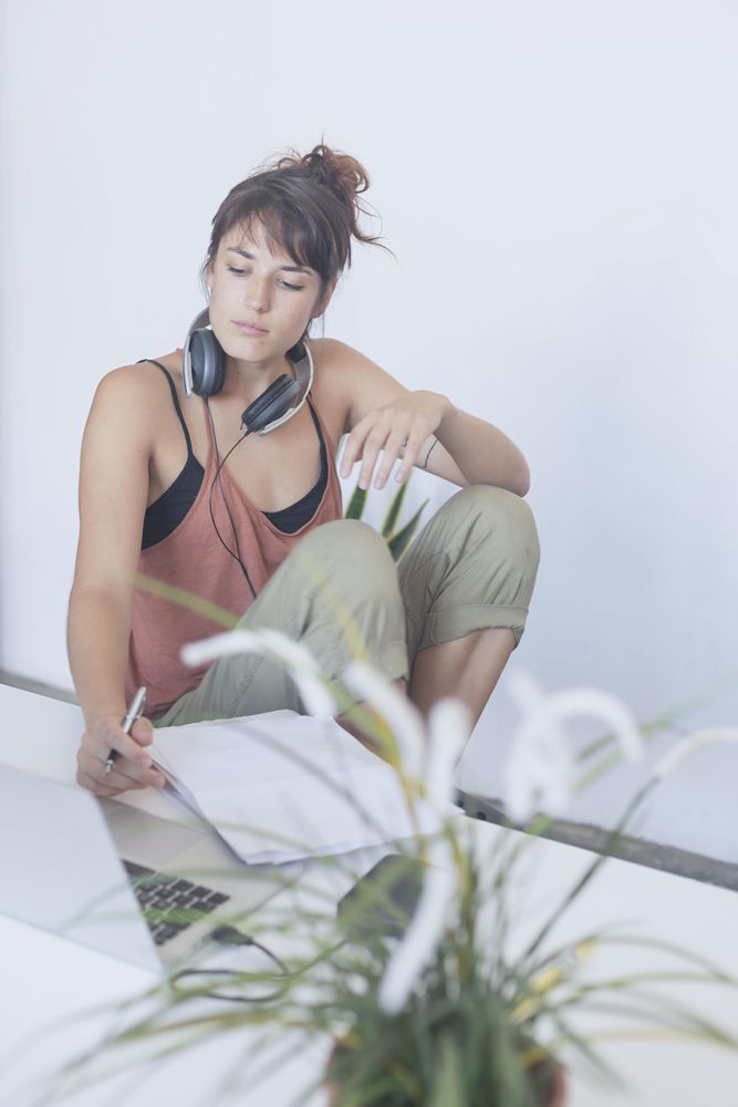 Woman sitting at desk while taking notes