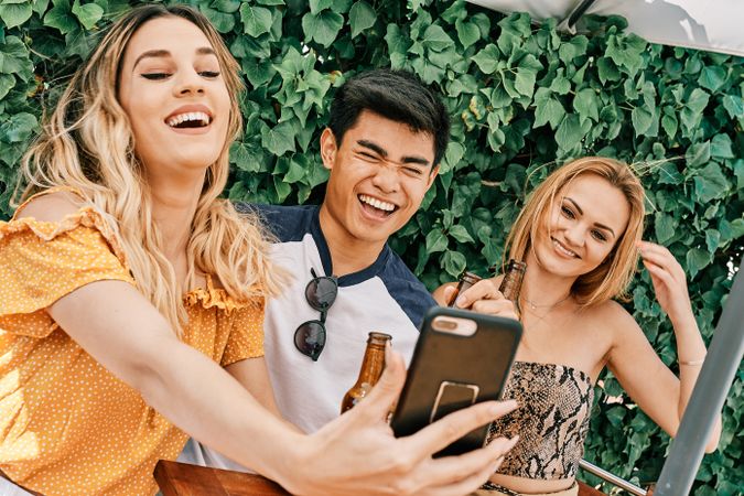 a group of young people making a selfie with last generation mobile phone