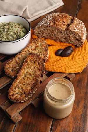 Tasty sauces decorated with sesame seeds and lush bread