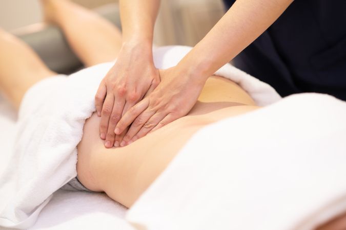 Female receiving a back massage in a physiotherapy center