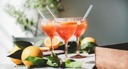 Three Aperol Spritz aperitif alcohol drink in glasses, horizontal