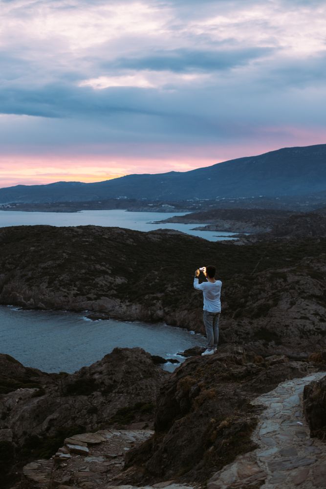 Solo man overlooking coast as the sun goes down