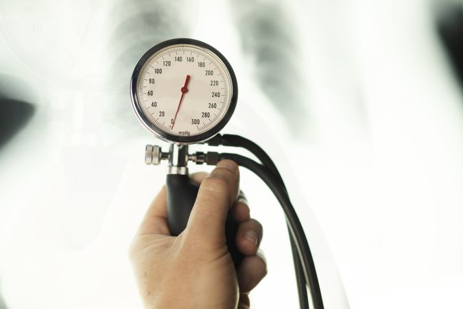 Doctor with pulsometer near x-ray film