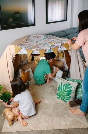 Family preparing tent to camping at home