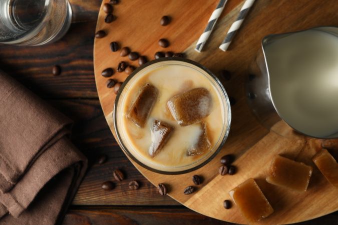 Composition with ice coffee on wooden background, top view