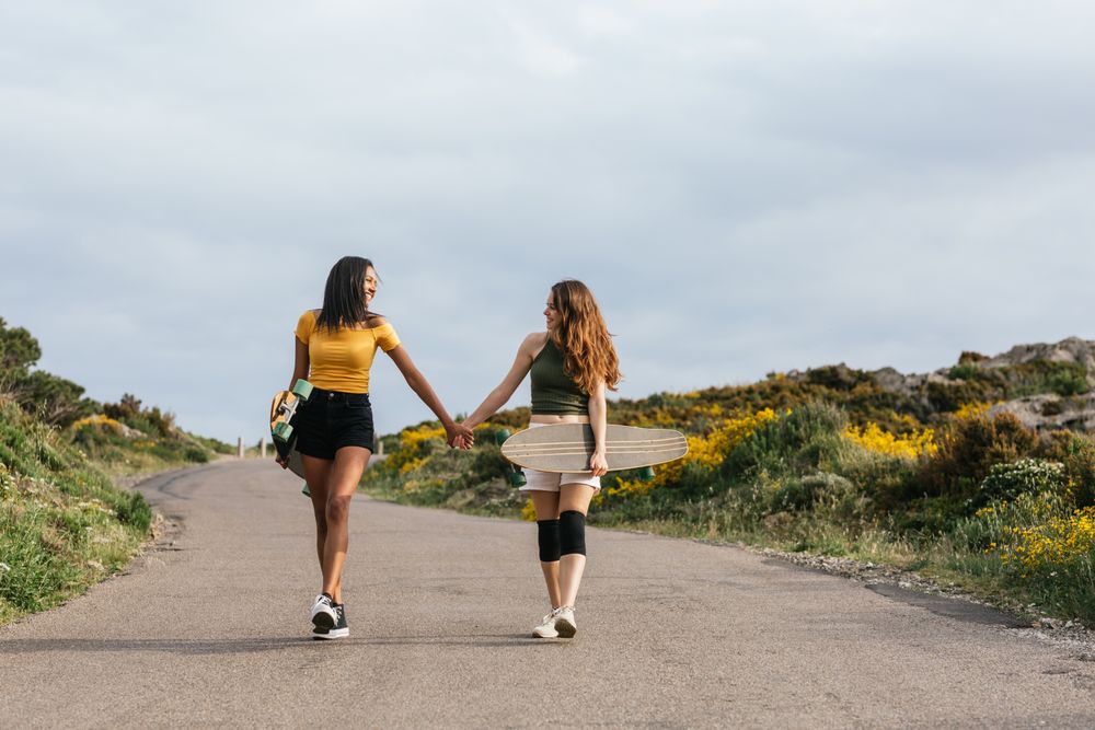 Cheerful diverse women walking on the road