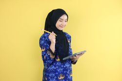 Young FemaleWorker Wearing Korpri Batik Uniform