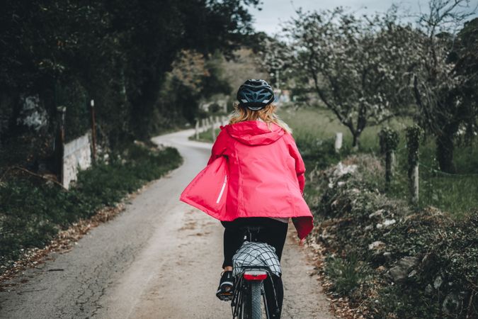 Female riding bicycle in countryside road