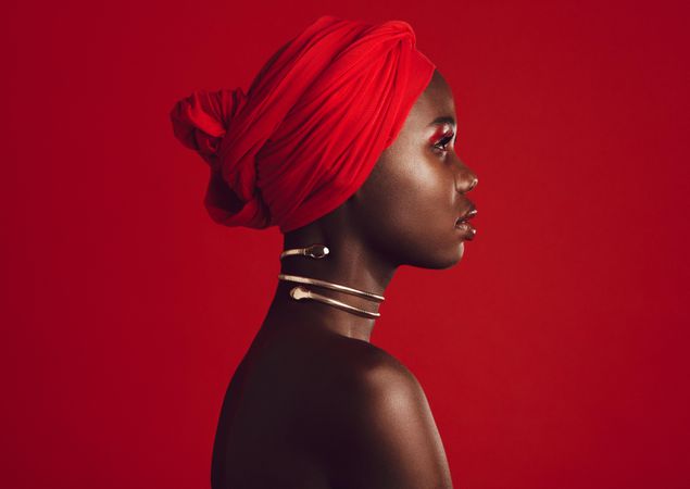 Side view of a woman wearing red turban