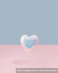 Iridescent sequins heart on and pink background 4ddyl4