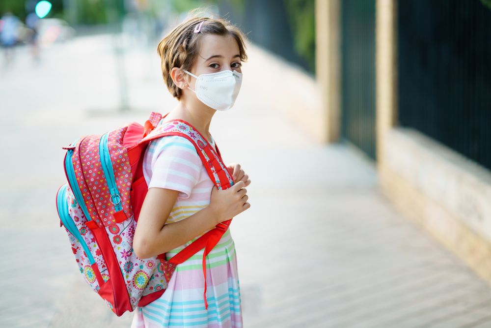 Girl in mask and backpack