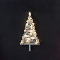 Christmas tree made of planks of wood with lights on dark background