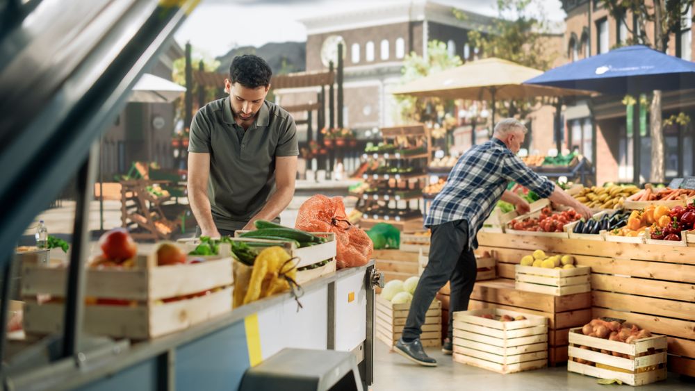 Team of Multiethnic Farmers Preparing Food Stalls for Selling Fresh Organic Farm Produce.