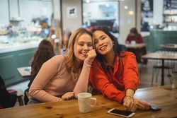 Multiethnic friends talking in cafe