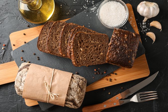 Composition with bread on cutting board, top view
