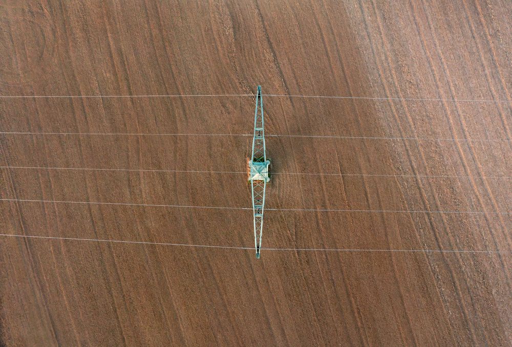 Drone shot with electricity pylon directly above