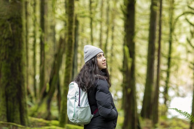 Young woman in the woods looking up