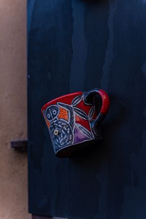 Ceramic cups as a handle on old door