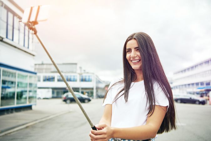 Brunette woman smiling and taking a self portrait