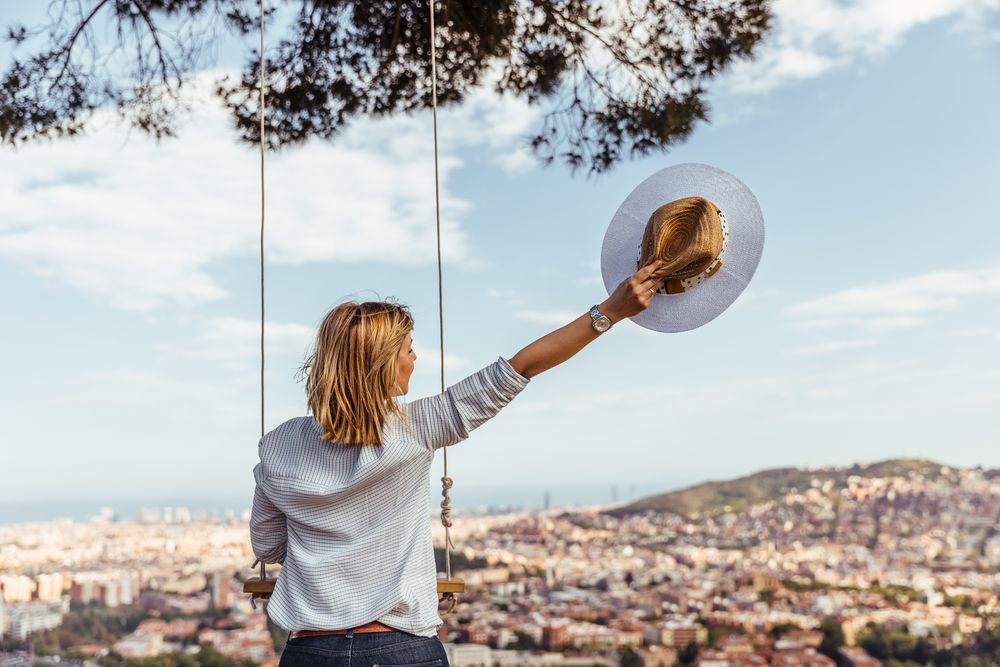 Female with hat watching the city