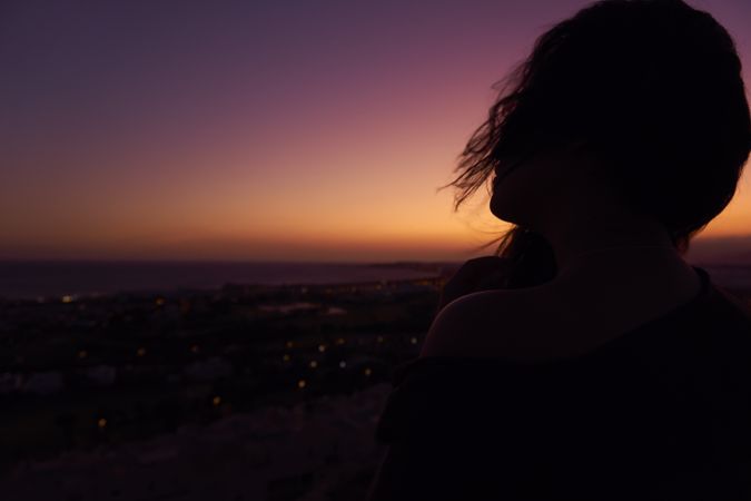 Silhouette of female enjoying picturesque sunset