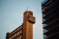 Looking up at apartment buildings in London on clear day