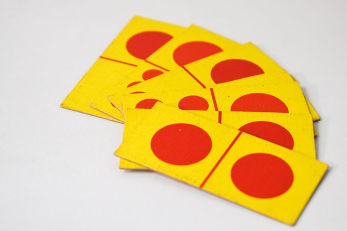 Red and yellow domino cards spread on table