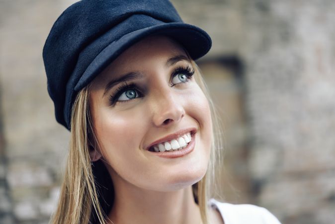 Portrait of happy woman in cap