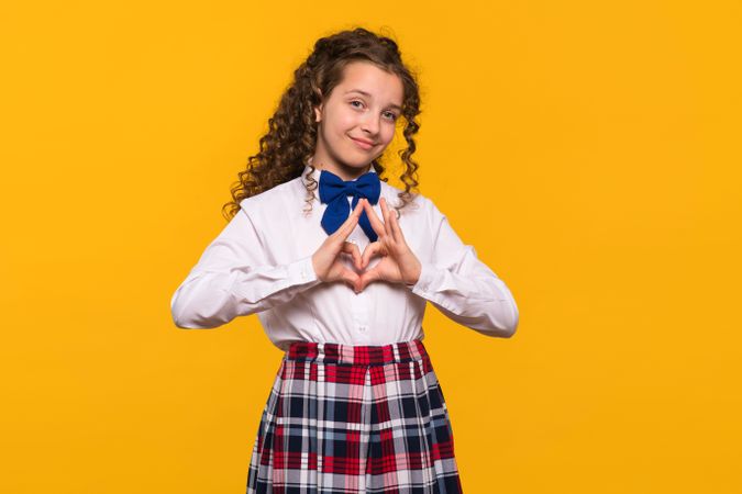Girl making heart gesture with hands