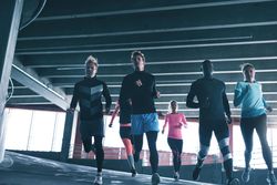 Group of runners jogging down a decline