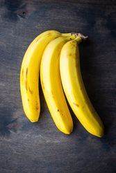 Fresh banana bunch on wooden background