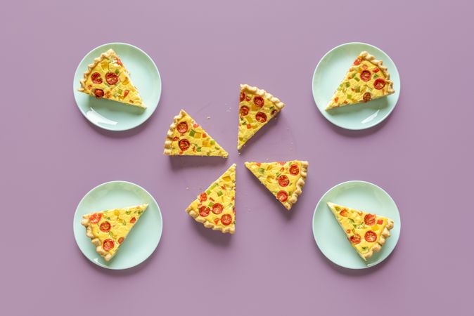 Quiche meal on a purple table, above view