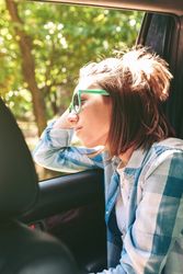 Young woman looking landscape through the window car