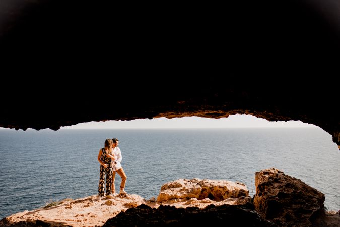 Couple embracing on rock