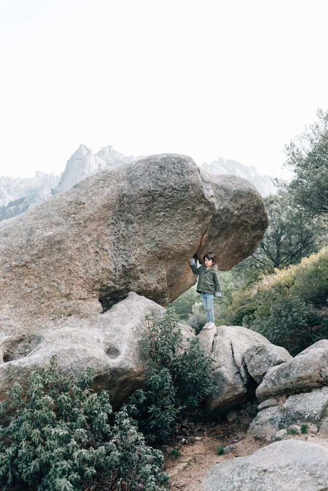Boy walking on rocky hill