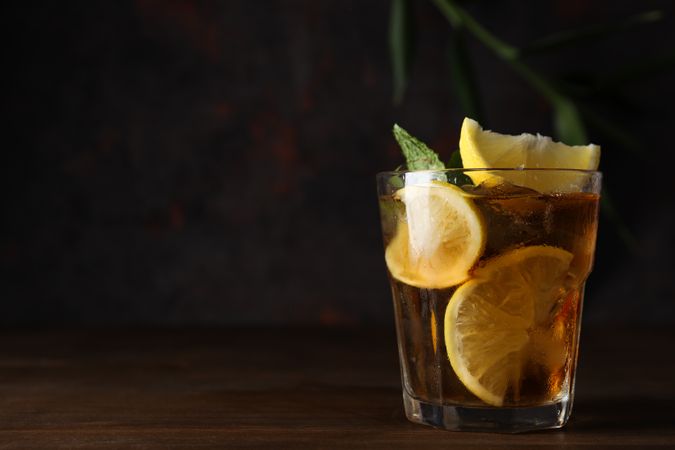 A glass of cold tea on a dark background
