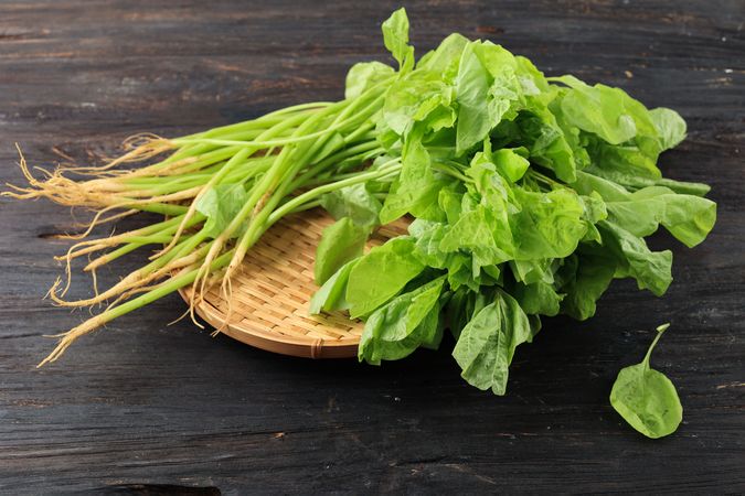 Bunch of fresh spinach on basket