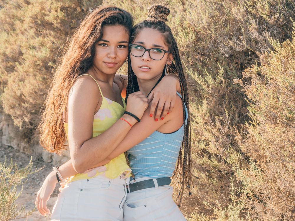 Happy trendy young women bonding at countryside