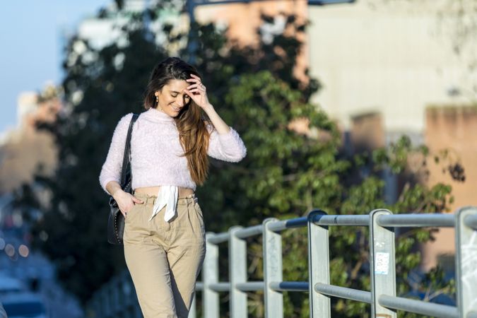 Happy woman in casual wear going for a stroll in the city