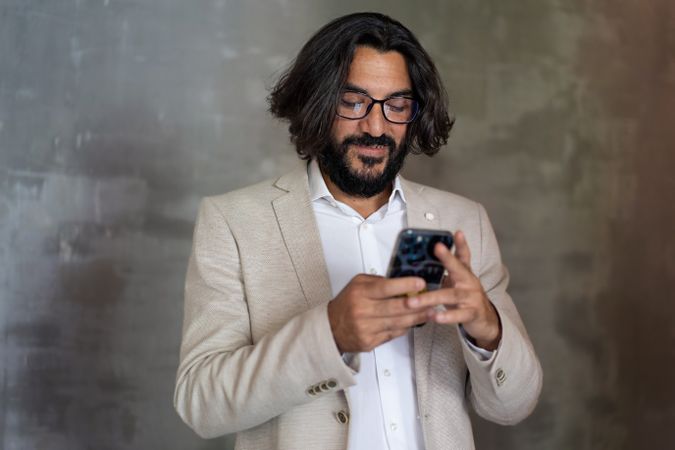 Young Arab businessman using smartphone with a smile
