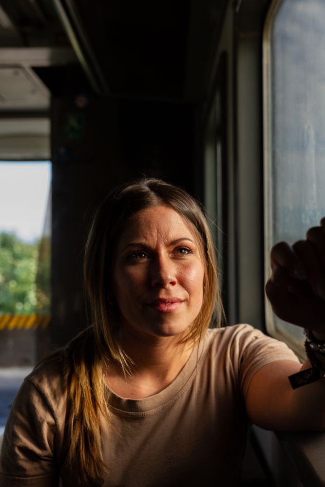 Military woman travelling looking out van window