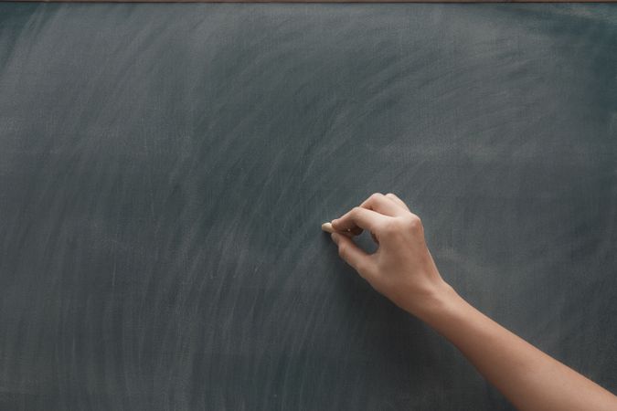 Hand on chalkboard