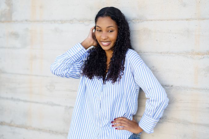 SelfAssured Young Woman Posing Gracefully Against a Contemporary Concrete Wall Background