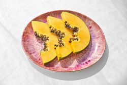 Plate with sliced juicy papaya