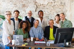 Portrait of successful group of multi-ethnic business people at modern office looking at camera
