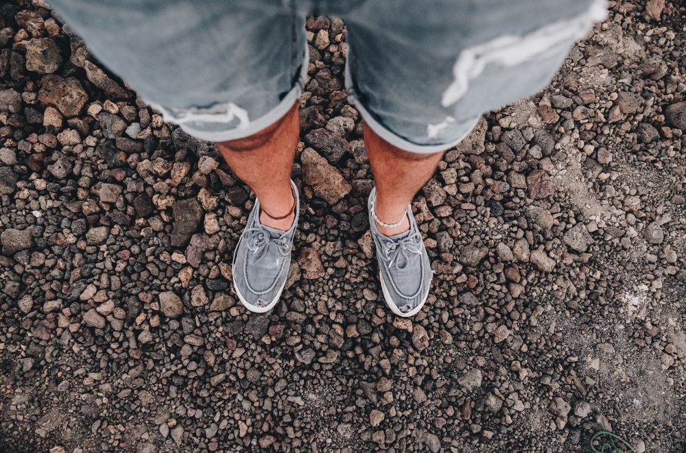 Crop legs on road from above