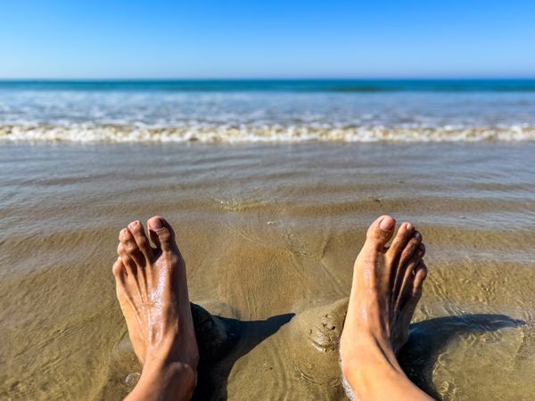 Wet feet in the sand at low tide, ile de Ré, France