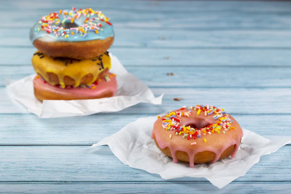 Delicious assorted colorful donuts on the table.