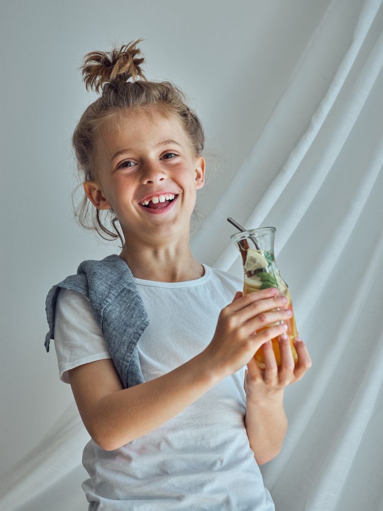Happy boy with glass of lemonade